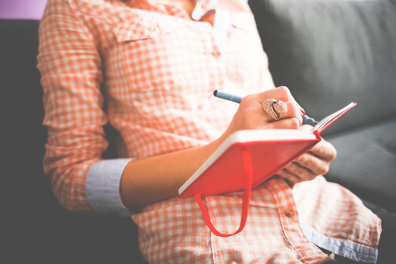 Woman writing in a diary